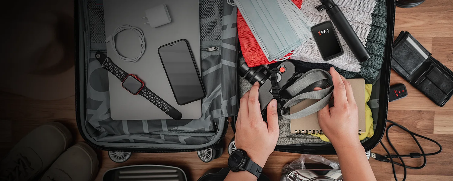 Inside a well organized suitcase with luggage tracker placed along with photography gadgets